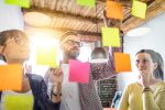 people working with post it notes